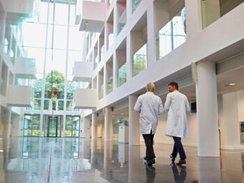 Two doctors walking in a healthcare facility lobby